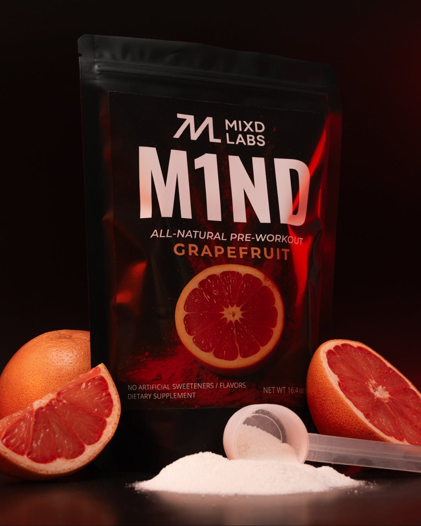 M1ND pre-workout supplement packaging with grapefruit slices on a dark background