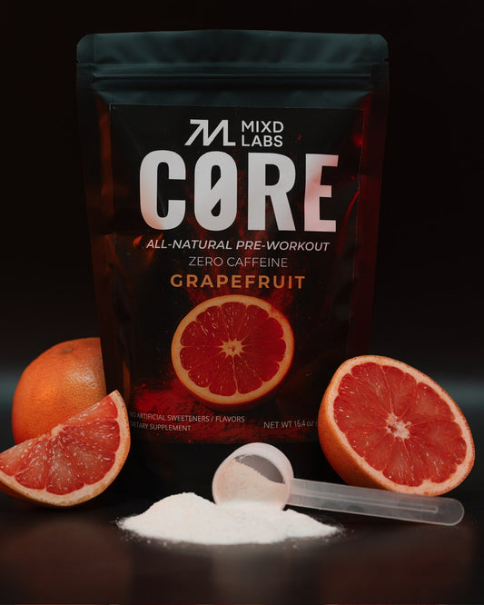 MIXD LABS CORE pre-workout supplement package with grapefruit slices and a scoop of powder on a dark background
