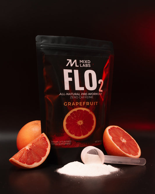 MIXD LABS FLO2 grapefruit pre-workout powder with grapefruit slices on a dark background